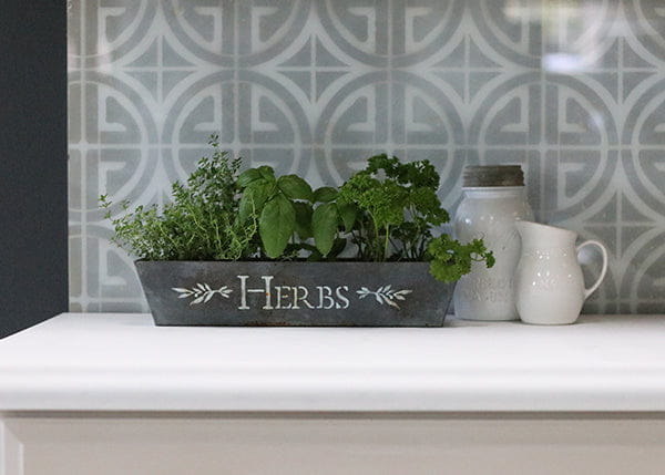 Dark gray herb planter stenciled in white using zinc antiquing solution