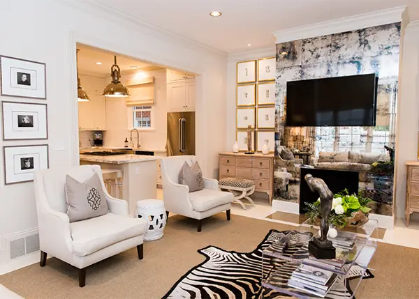 White upholstered armchairs with gray pillows in Antique Mirror Solution